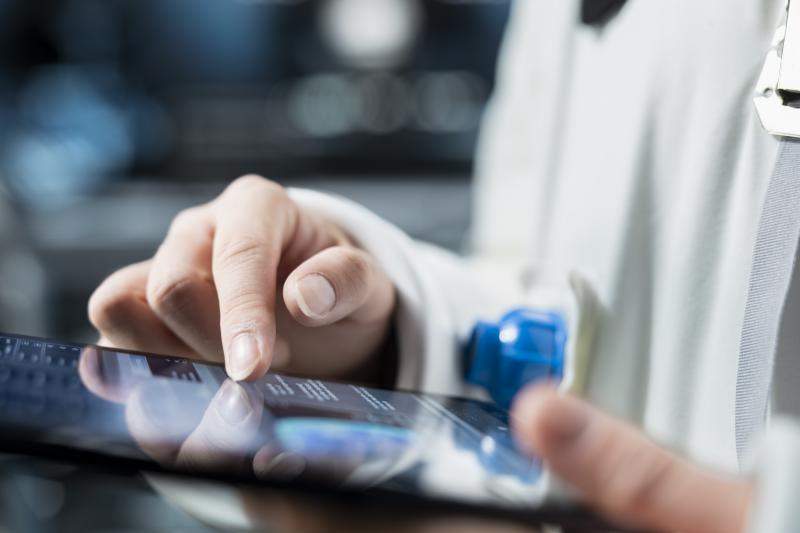close-up-astronaut-reviewing-spacecraft-metrics-tablet
